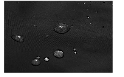 Close-up of water droplets on black water-resistant fabric texture