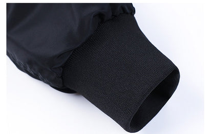 Close-up of black aviator jacket sleeve with elastic ribbed cuff on white background