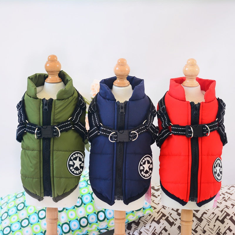 Three waterproof insulated dog jackets in green, navy, and red with built-in leash harness on mannequins