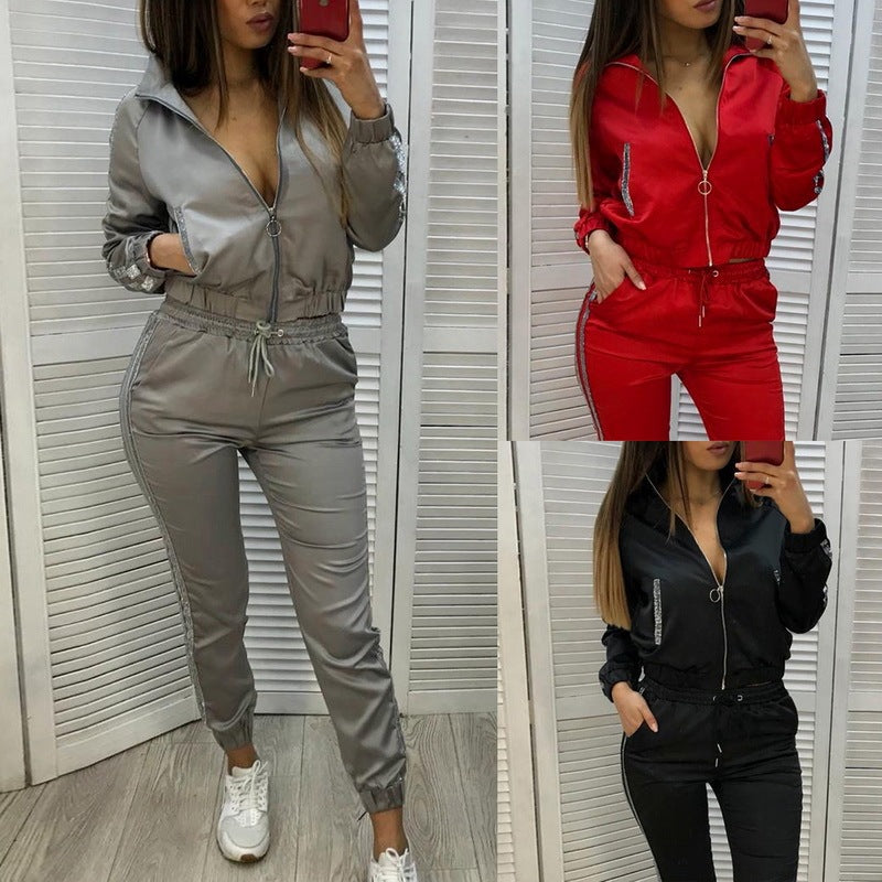 Women wearing stylish polyester two-piece sports suits in gray, red, and black with zipper jackets and jogger pants