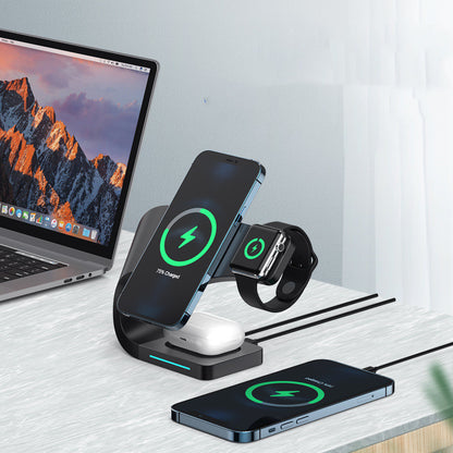 Black 15W magnetic wireless charger stand charging smartphone, smartwatch, and earbuds on white desk