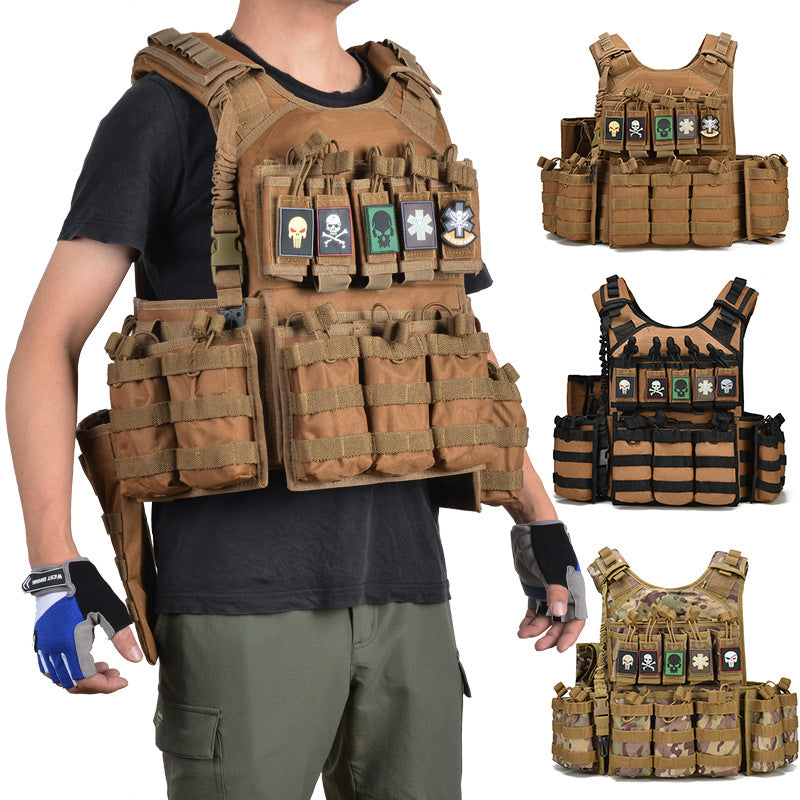 Tactical vest in black mud and camouflage colors with multiple pouches and patches featuring skull and medical symbols