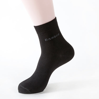 Black mid-calf bamboo socks displayed on a mannequin foot with white background