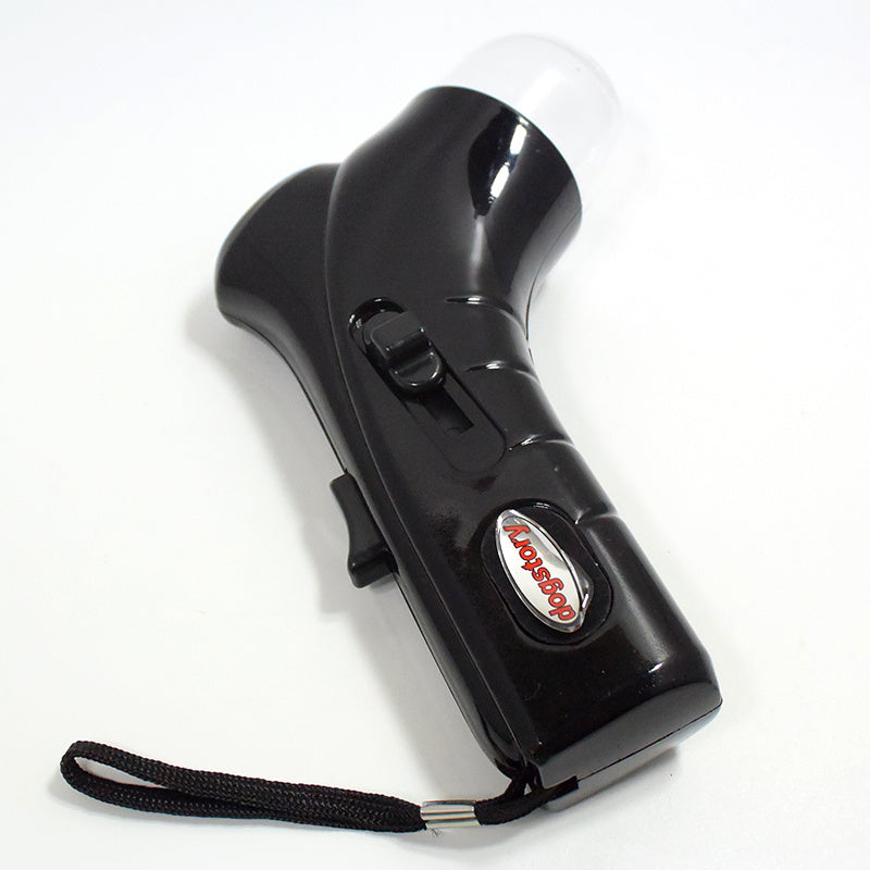 Black ergonomic pet treat launcher with wrist strap and slider button on white background