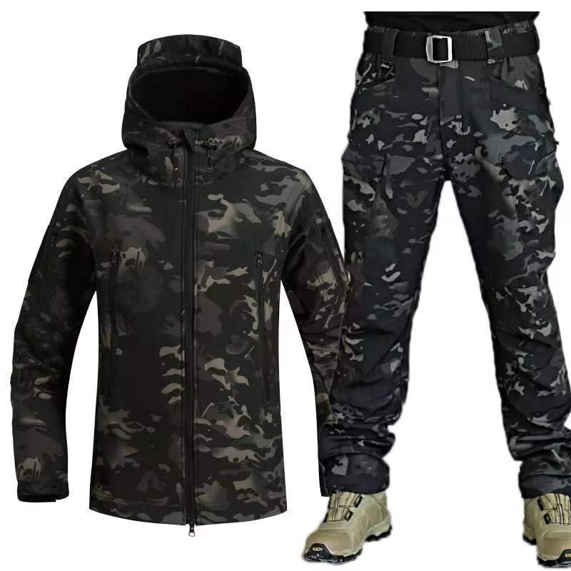 Men's black camouflage winter training suit with hooded jacket and cargo pants, paired with tan boots