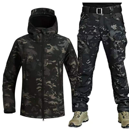 Men's black camouflage winter training suit with hooded jacket and cargo pants, paired with tan boots
