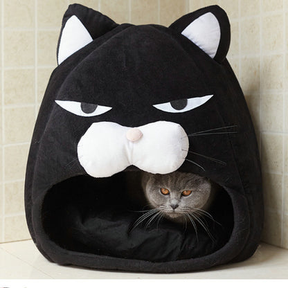 gray cat resting inside black cozy cat bed shaped like a cat face with white details