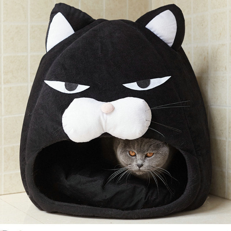 Gray cat inside black cozy plush cat bed shaped like cat face with ears on tiled floor