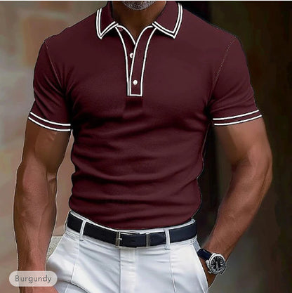 Man wearing burgundy short sleeve polo shirt with white trim, white pants, black belt, and watch
