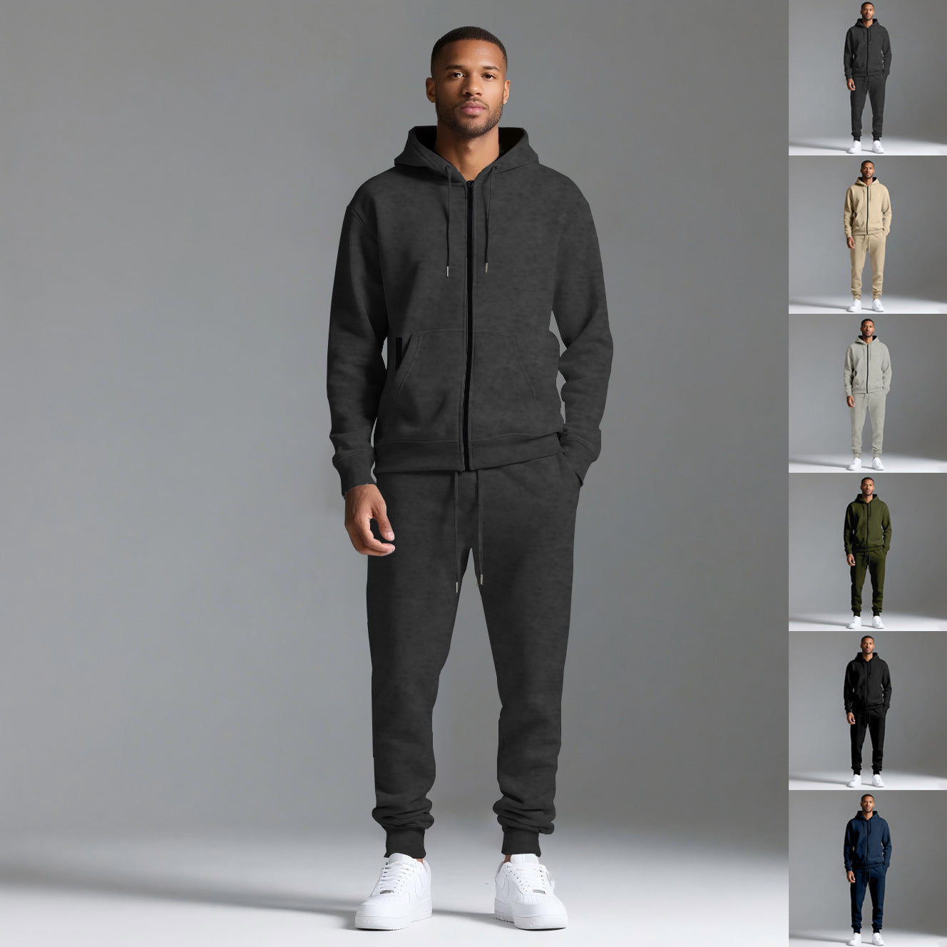 Man wearing black hooded sportswear cotton blend tracksuit set with white sneakers on gray background
