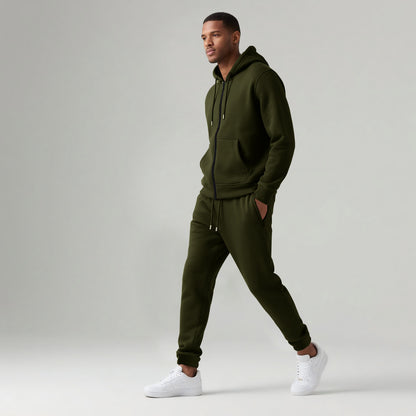 Man wearing olive green cotton blend hooded zip-up tracksuit with joggers and white sneakers