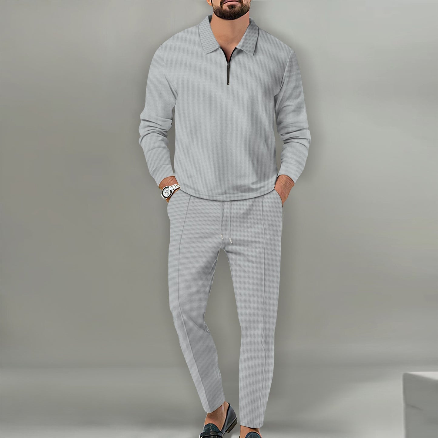 Man wearing light gray waffle knit cotton blend long sleeve zip-up top and matching pants outfit