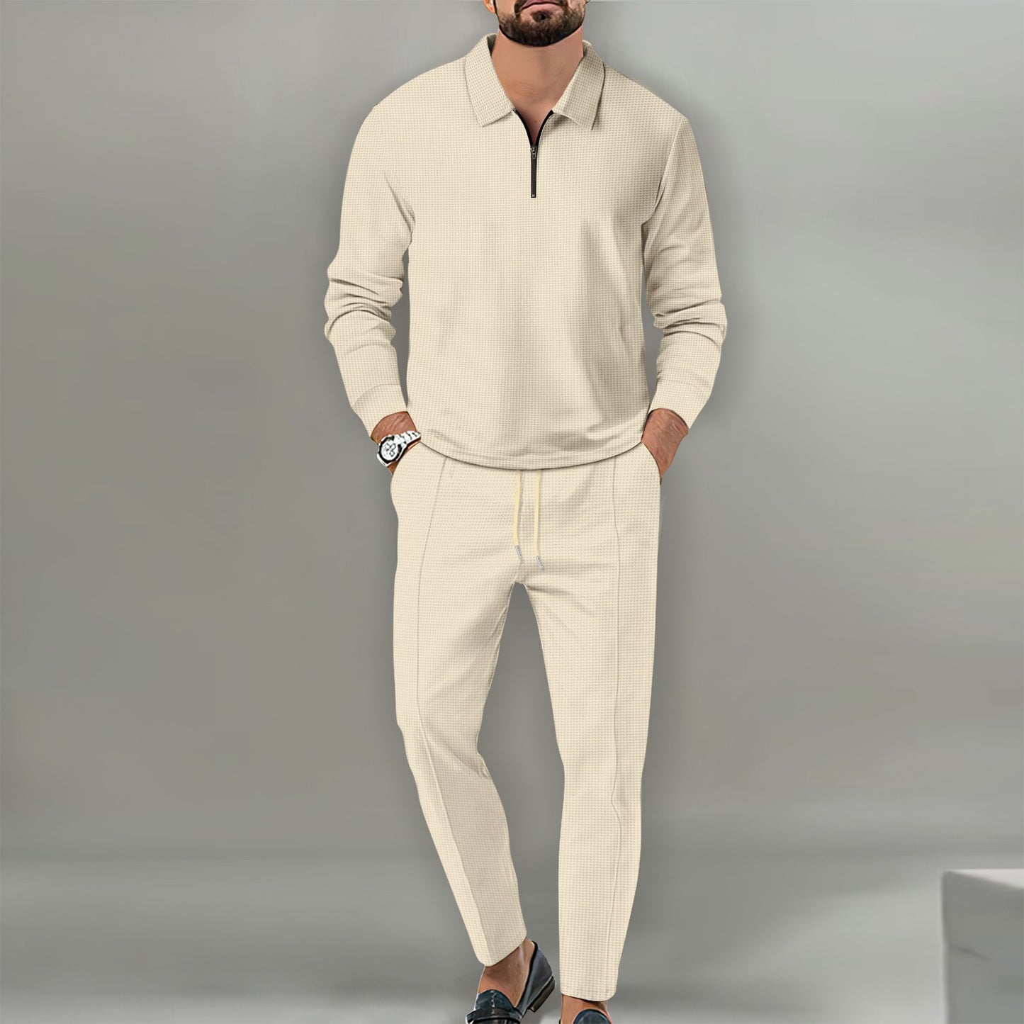 Man wearing beige waffle knit cotton blend long sleeve zippered sweater and matching trousers outfit