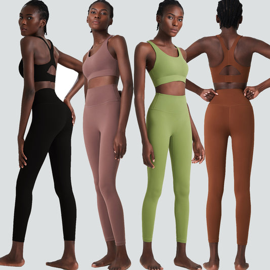Woman modeling four sets of seamless yoga workout clothes in black, mauve, green, and brown with unique sports bra backs
