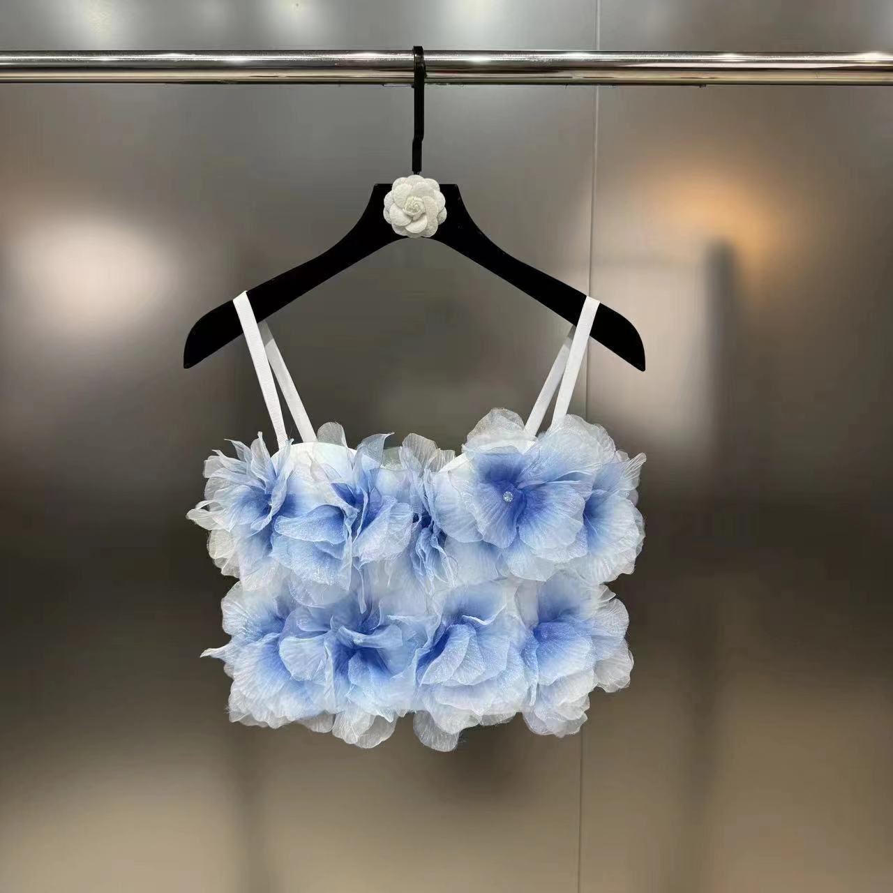 Blue and white floral 3D flower crop top with double white straps on black hanger