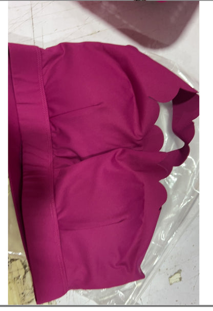 Magenta padded women's sports bra with scalloped edges on straps and band