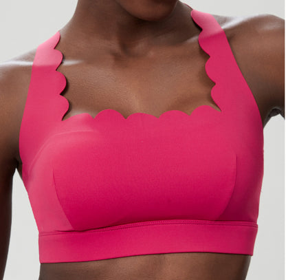 Plus size women's hot pink sports bra with scalloped edges and seamless design
