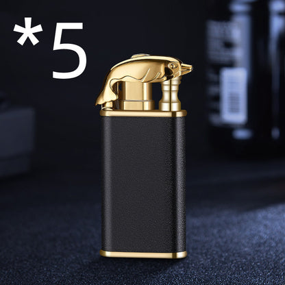 Black and gold metal cigarette lighter with dolphin-shaped top and textured grip