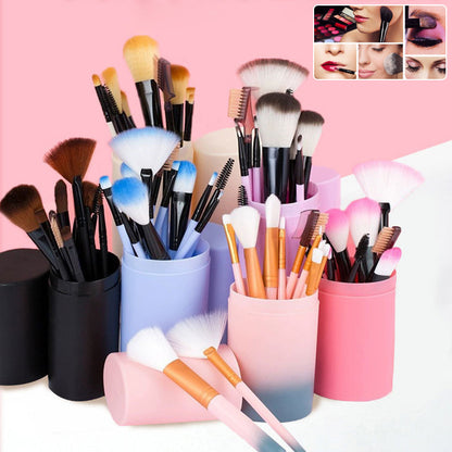 12-piece colorful makeup brush set with soft bristles in pastel holders on pink background