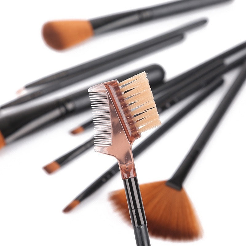 Close-up of black cosmetic brush set including brow comb and fan brush with soft rayon bristles