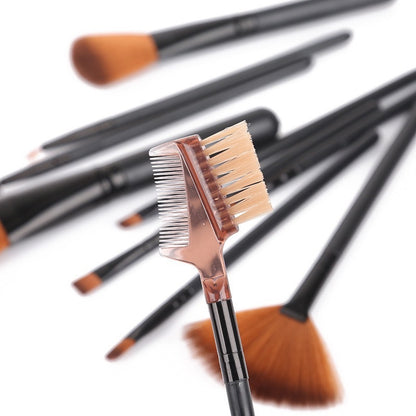 Close-up of black cosmetic brush set including brow comb and fan brush with soft rayon bristles