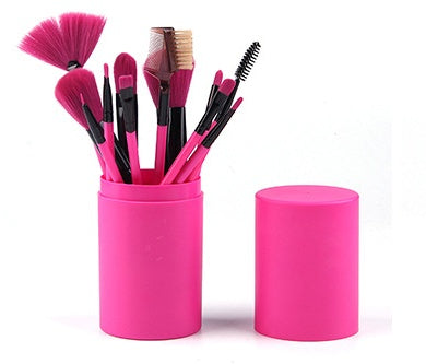 12-piece pink makeup brush set with assorted soft bristles in cylindrical holder with lid