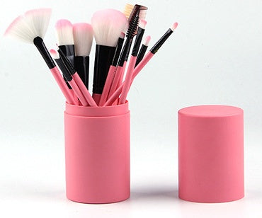 12-piece pink makeup brush set with soft bristles in pink holder with lid