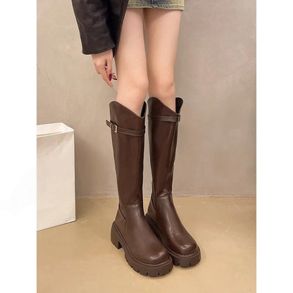 Women wearing dark brown leather knee-high chunky heel boots with buckle detail