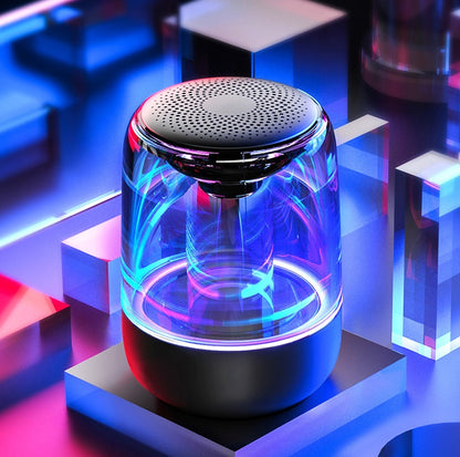 Black portable Bluetooth speaker with 6D bass and RGB lights glowing in neon blue and purple