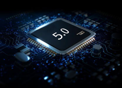 Close-up of a black microchip labeled 5.0 mounted on a blue circuit board with electronic components