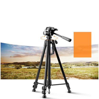 Black aluminum camera tripod with three adjustable legs and swivel head on white background