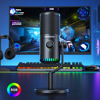 Black Maono gaming microphone with RGB lighting on desk in front of PC gaming setup with keyboard and headset