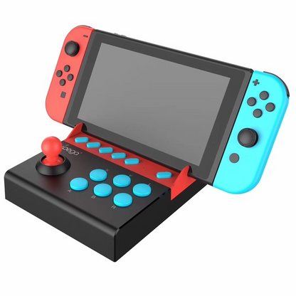 Black Trendoligy fighting stick controller with red joystick and blue buttons attached to Nintendo Switch with red and blue Joy-Con