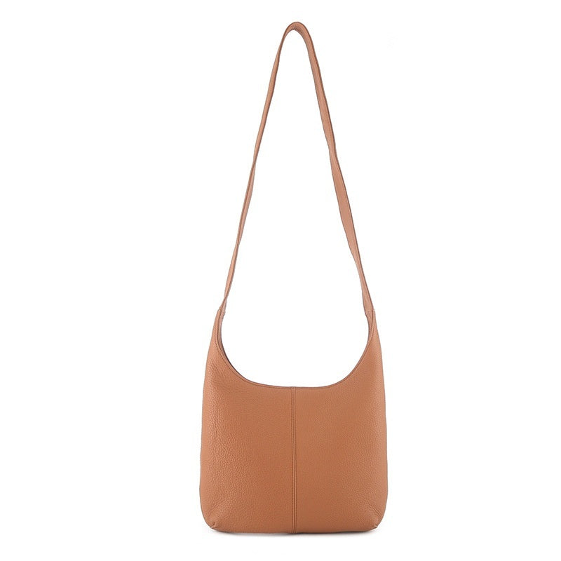 Tan genuine leather casual women's crossbody bag with long strap on white background