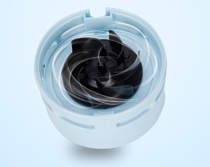 Close-up of spinning black fan blades inside a light blue circular housing on a light blue background