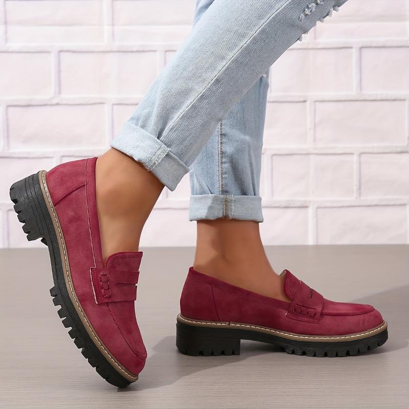 Trendy women's thick-soled burgundy suede loafers paired with rolled-up light blue jeans