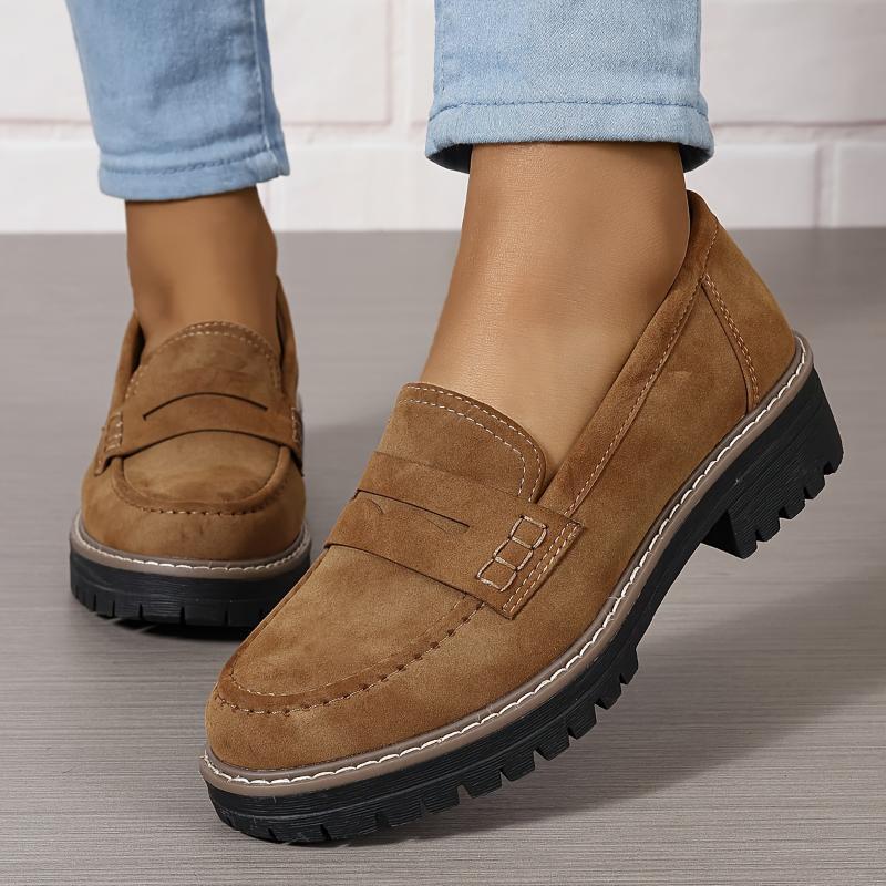women's brown suede loafers with thick black lug soles worn with light blue jeans