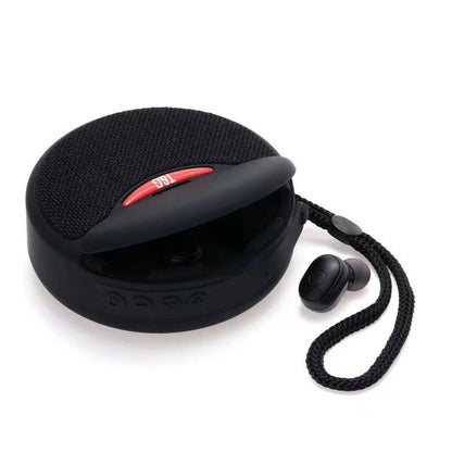 Black round portable Bluetooth speaker with fabric top and detachable braided strap with single wireless earbud