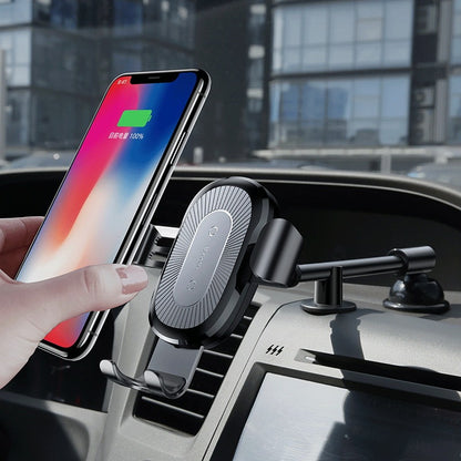 Black wireless car charger gravity mount holding smartphone with 100% charge on car dashboard