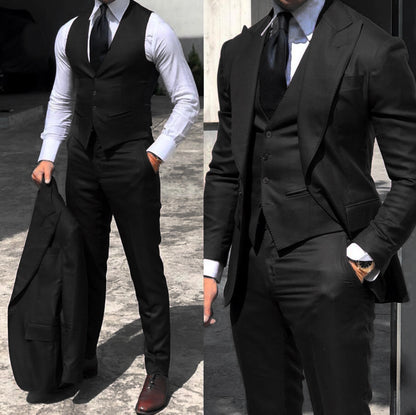 Men's black slim-fit three-piece suit with cotton fabric, white shirt, and black tie in outdoor setting