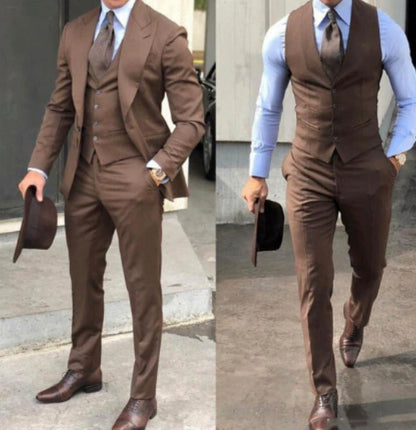 Men's brown slim fit three-piece suit with matching tie and brown dress shoes, styled with a hat
