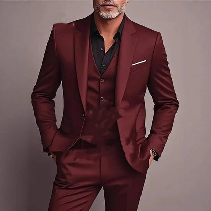 Man wearing a slim-fit dark red three-piece suit with a black shirt and white pocket square