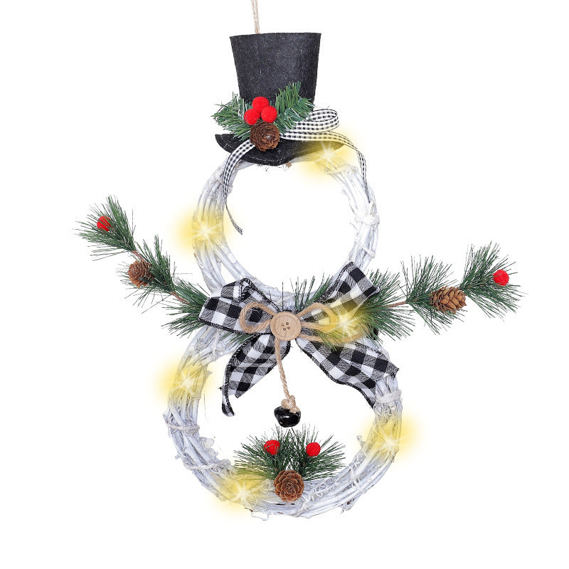 White LED snowman wreath with black top hat, checkered bow, pine cones, red berries, and green pine needles