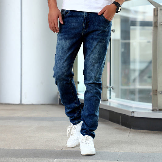 Man wearing blue slim fit stretch denim jeans with casual white sneakers