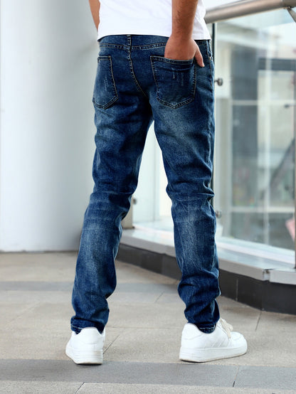 Back view of man wearing slim fit blue denim jeans with mid waist, casual pants and white sneakers