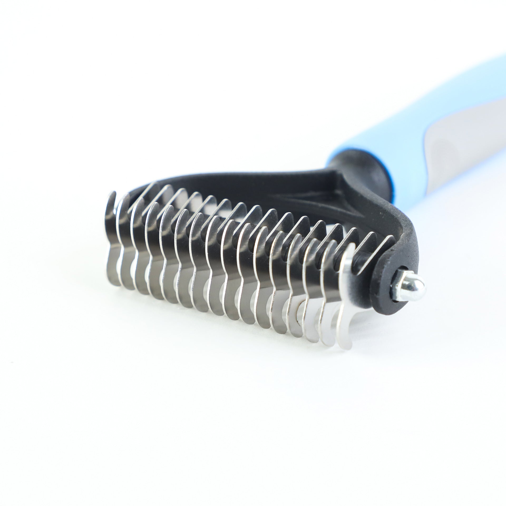 Close-up of blue and black double-sided pet shedding comb with stainless steel blades and ergonomic handle