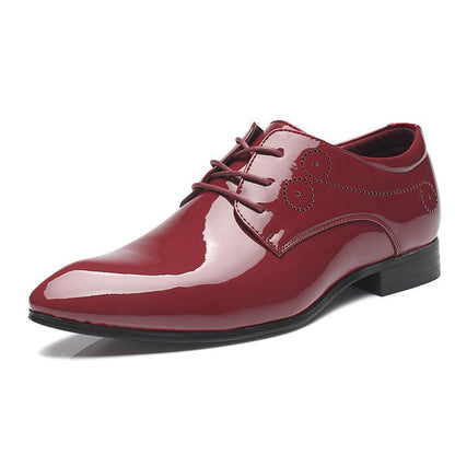Shiny maroon men's formal leather dress shoe with lace-up and decorative perforations