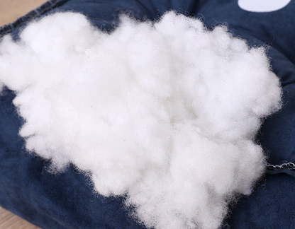Soft white PP cotton filling on a blue plush pet bed for cozy comfort