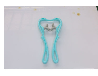 light blue roller neck massager with ergonomic handles on white surface