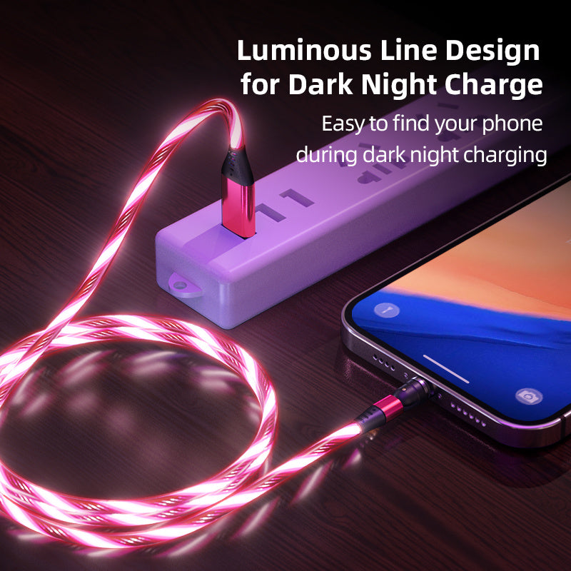 Pink luminous magnetic charging cable with LED flow light connected to smartphone and power strip on wooden surface